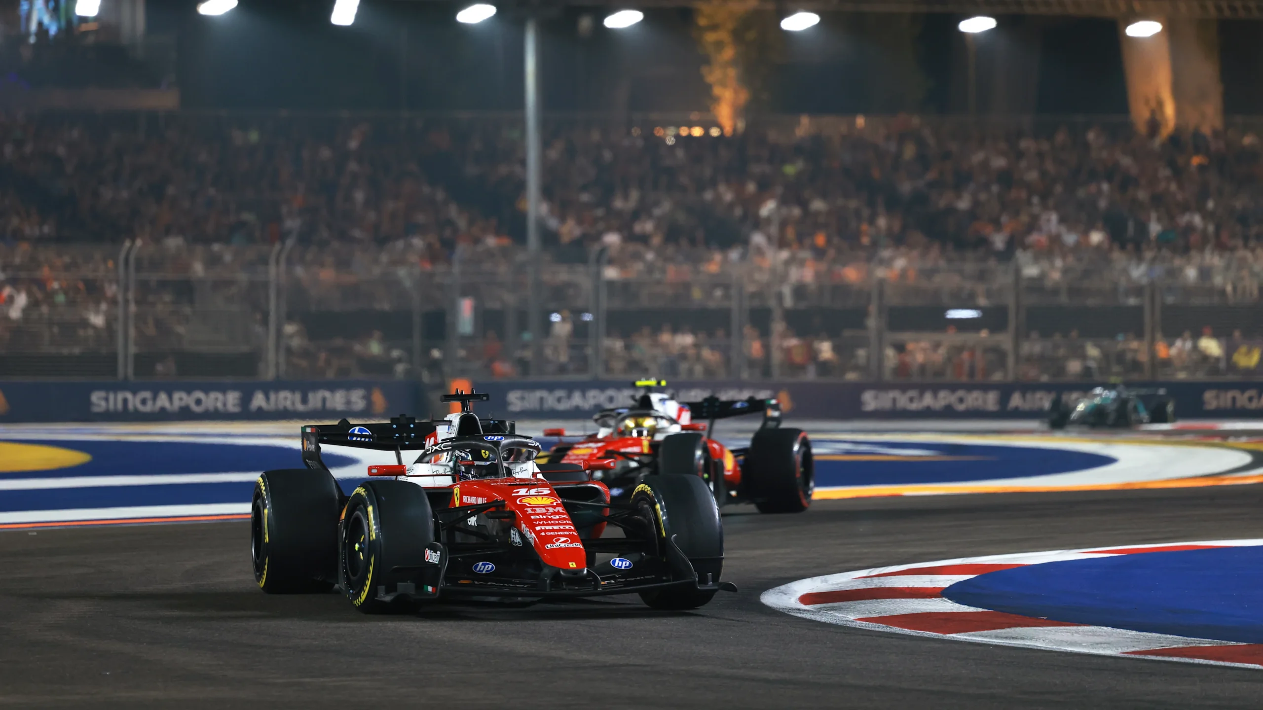 Charles Leclerc leads Lewis Hamilton in their Ferraris at Singapore