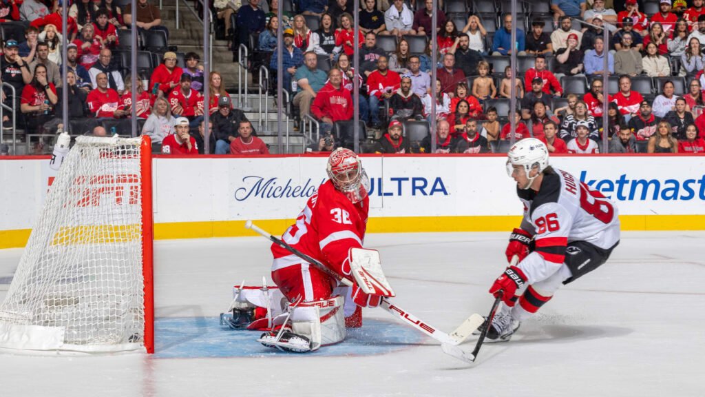 Jack Hughes, wearing Devils number 86, attacks the Detroit net in New Jersey’s October 13, 2026 game.