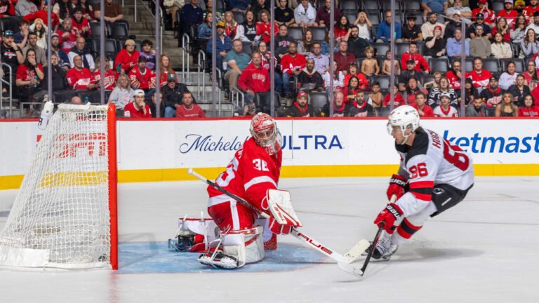 Jack Hughes, wearing Devils number 86, attacks the Detroit net in New Jersey’s October 13, 2026 game.