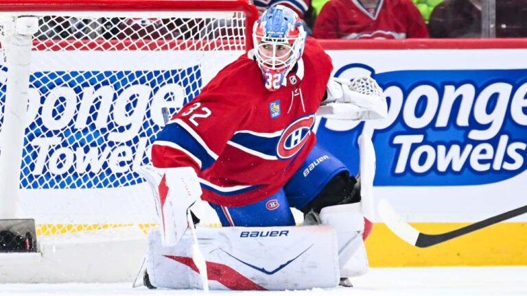 Jacob Fowler guarding the Canadiens net in a red Montreal uniform.