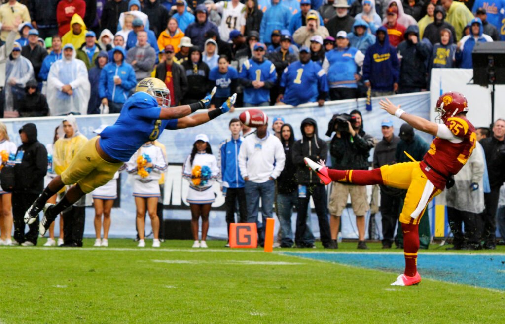 Eric Kendricks in a blue UCLA number 6 uniform blocks a USC punt in a November 17, 2012 file photograph.