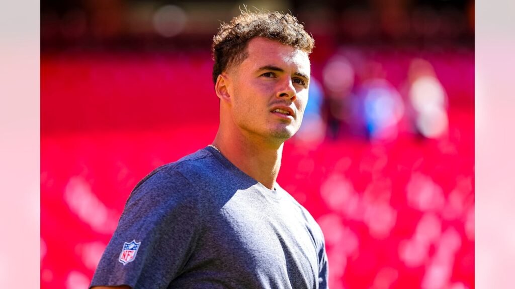 Ladd McConkey in a gray shirt on the field before the Chargers’ game at Kansas City.