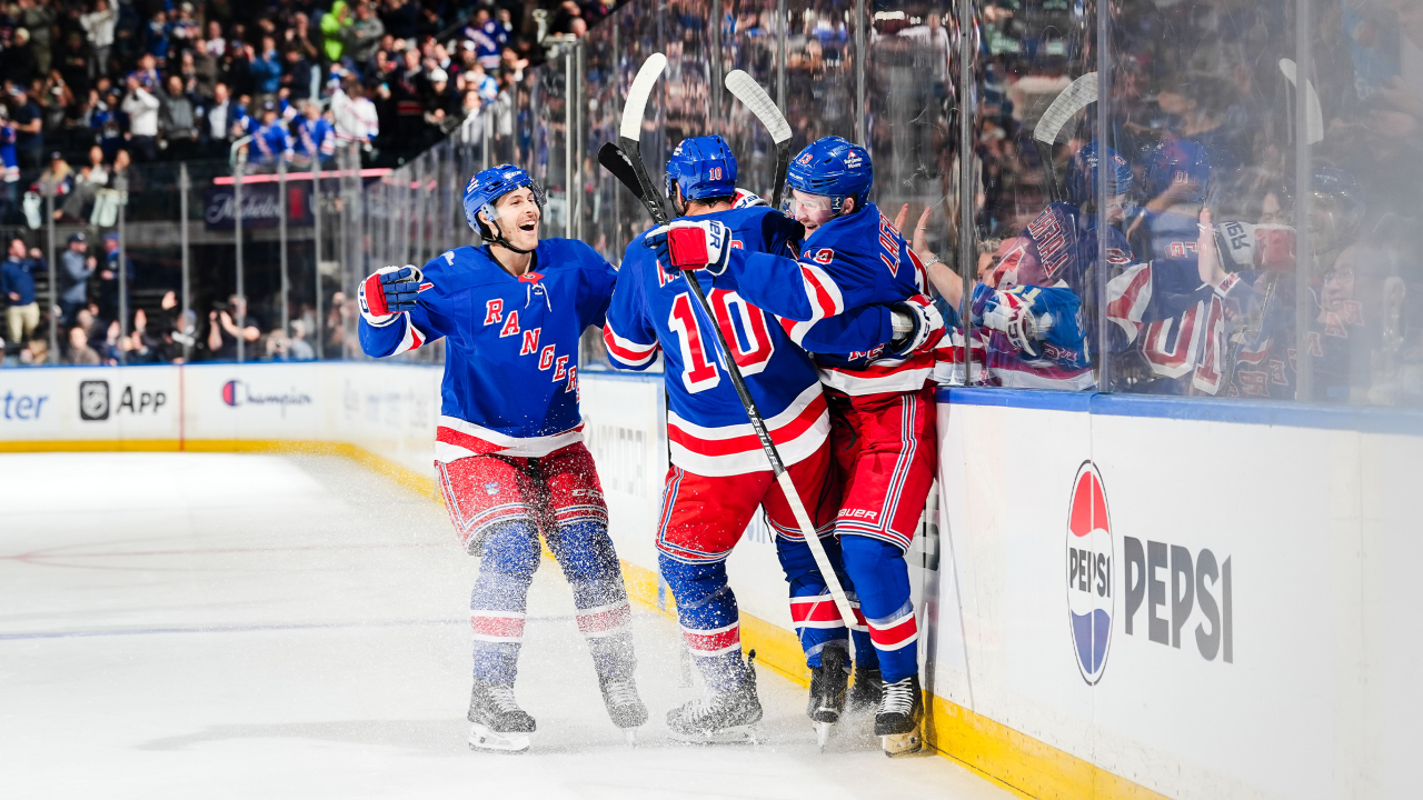 Alexis Lafrenière, number 13, celebrates with J.T. Miller and a Rangers teammate against Tampa Bay on October 13, 2026.