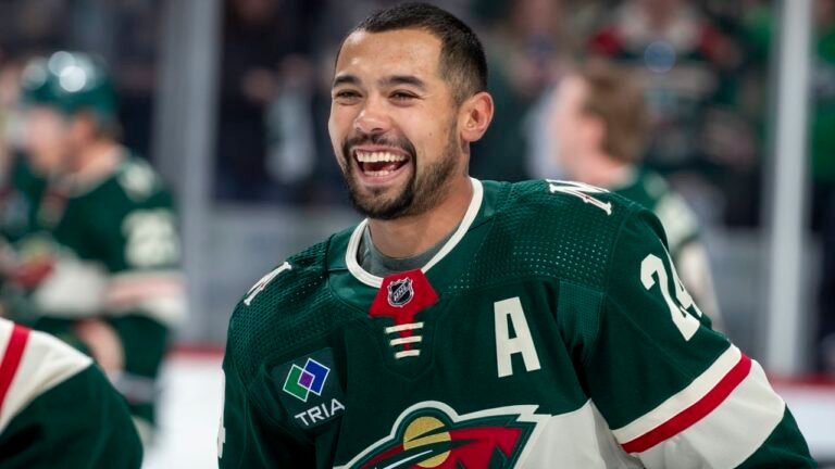 Matt Dumba smiles in a Minnesota Wild uniform.