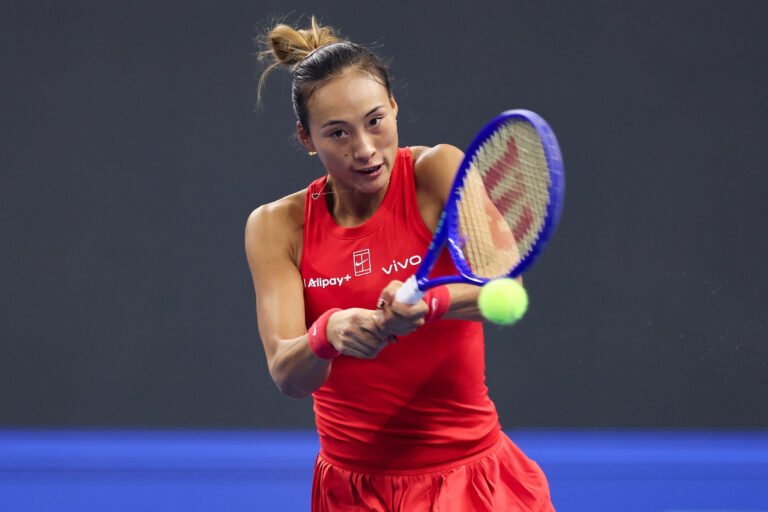 Zheng Qinwen hits a backhand at the China Open.