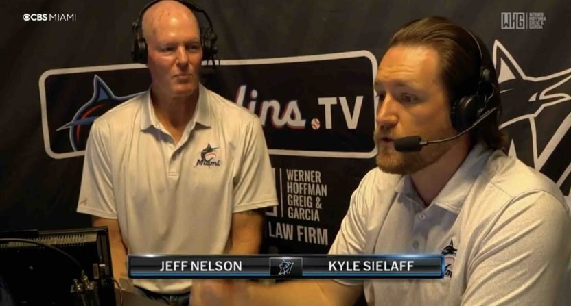 Jeff Nelson, left, and Kyle Sielaff wear headsets in the Marlins television broadcast booth.