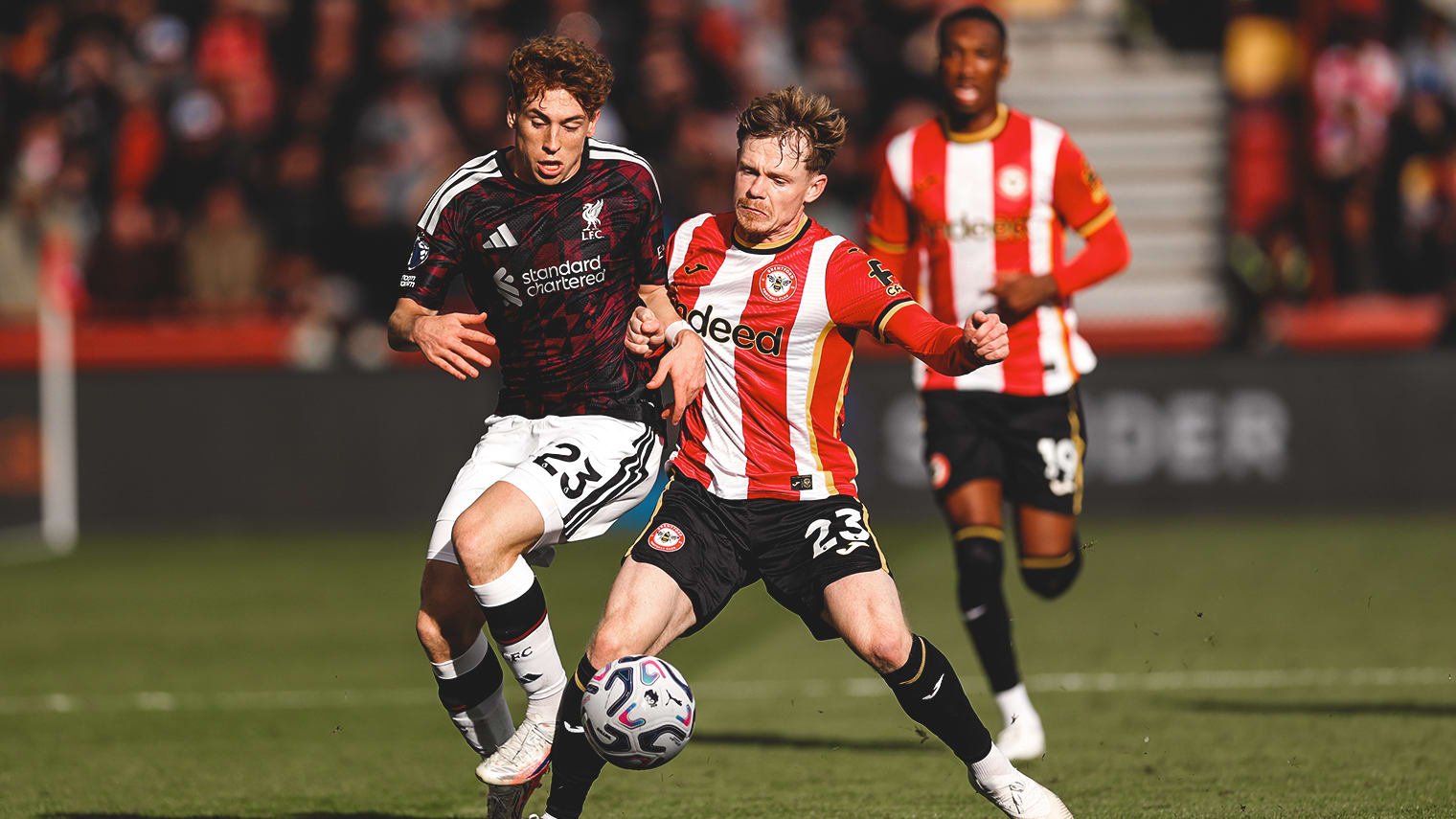 Liverpool and Brentford players contest the ball at Gtech Community Stadium.