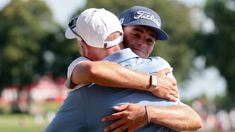 Jackson Koivun embraces his father George after the 3M Open.