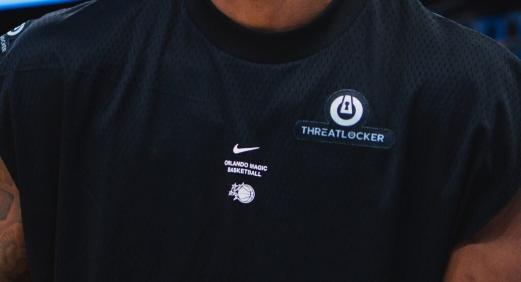 ThreatLocker branding on an Orlando Magic warmup shirt.