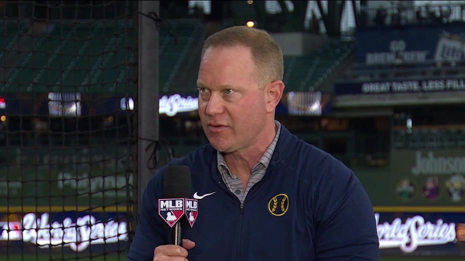 Matt Arnold holds an MLB Network microphone at American Family Field.