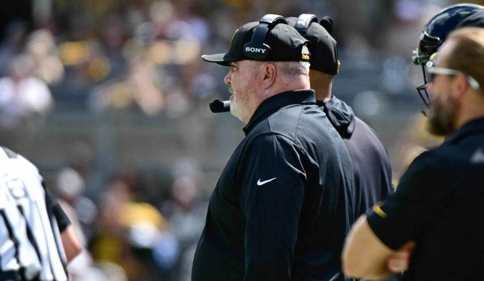 Mike McCarthy wearing a headset on the Steelers sideline.
