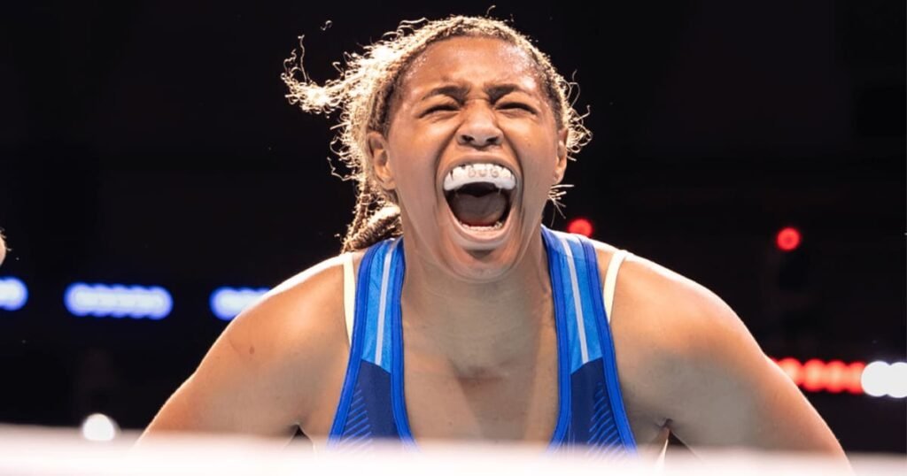 Marley McNealy celebrates in a blue USA Boxing uniform.