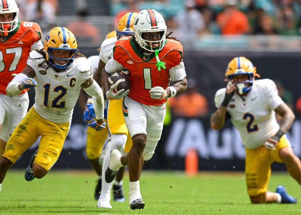 Malachi Toney runs between Pittsburgh defenders.
