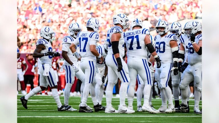 Indianapolis Colts players gather in a huddle during their London game against Washington.