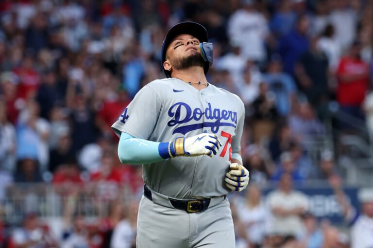 Miguel Rojas looking upward in a gray Dodgers uniform during NLDS Game 3 in Atlanta.