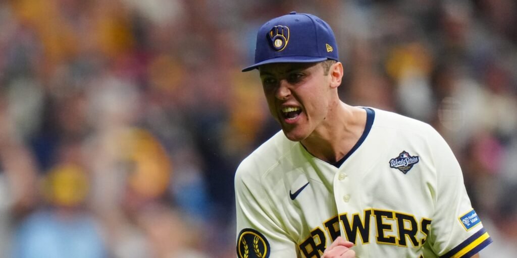 Jacob Misiorowski reacts in a Brewers uniform with a World Series patch.