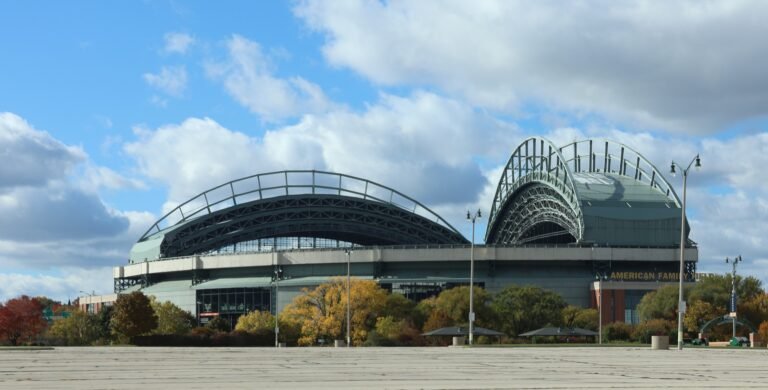Exterior of American Family Field in Milwaukee beneath a blue sky.
