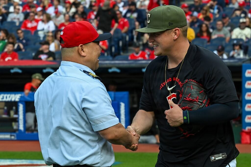 Cleveland pitcher Parker Messick shakes hands with Coast Guard Cmdr. Hoon Park