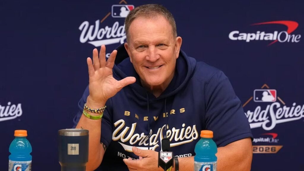 Pat Murphy smiles at a microphone in front of a 2026 World Series backdrop.