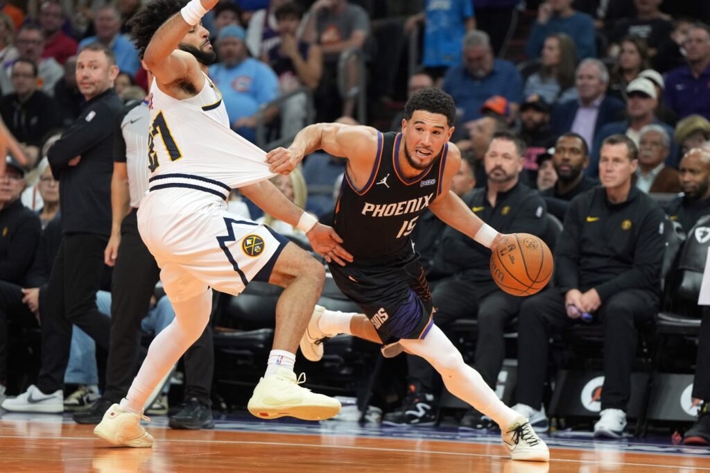 Jamal Murray defends against Devin Booker.