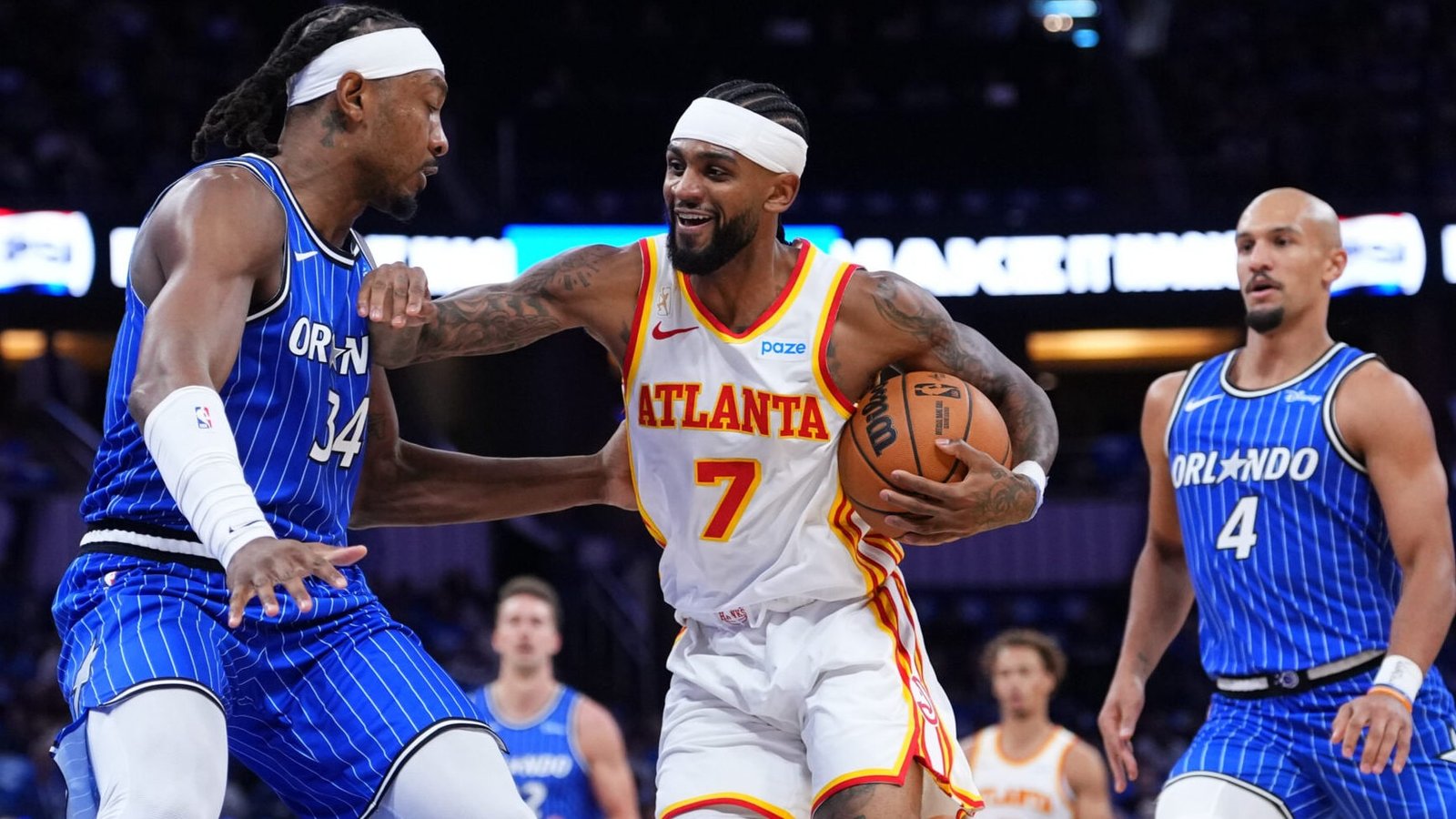 Wendell Carter Jr. and Jalen Suggs defend against Atlanta in Orlando’s season opener.