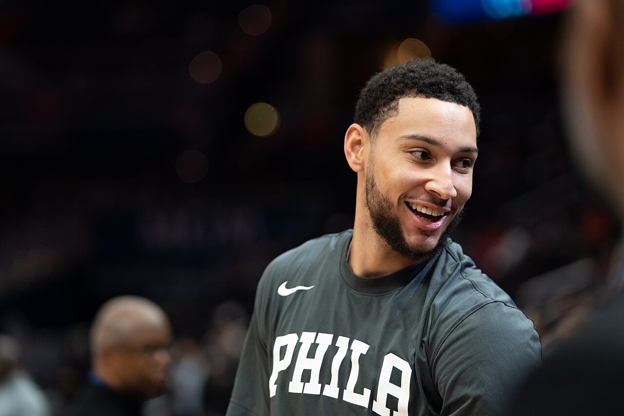 Ben Simmons smiling in a Philadelphia warmup shirt