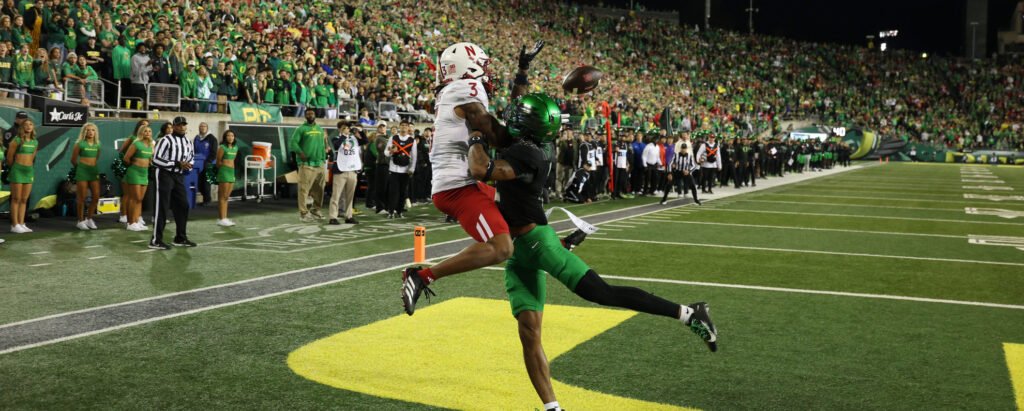 Nebraska and Oregon players contest a pass during their October 2026 game.