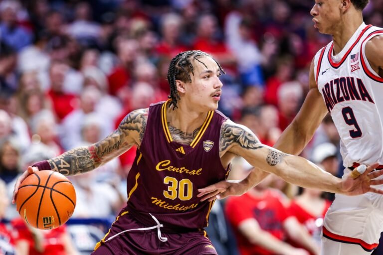 Anthony Pritchard in a maroon Central Michigan No. 30 jersey dribbling against an Arizona defender.