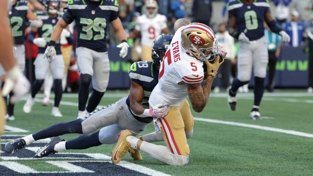 Mike Evans catches a two-point conversion as Seattle’s Josh Jobe tackles him in the end zone.