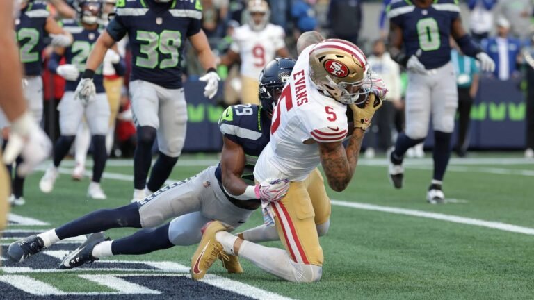 Mike Evans catches a two-point conversion as Seattle&rsquo;s Josh Jobe tackles him in the end zone.
