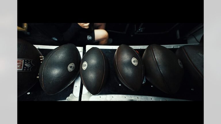 NFL footballs sit on a rack before the Raiders game in New Orleans.