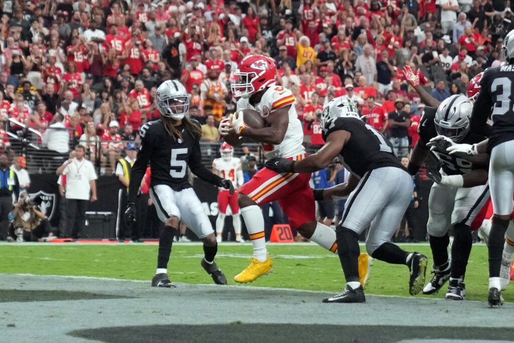 Chiefs running back Kenneth Walker III carrying the ball against the Las Vegas Raiders.