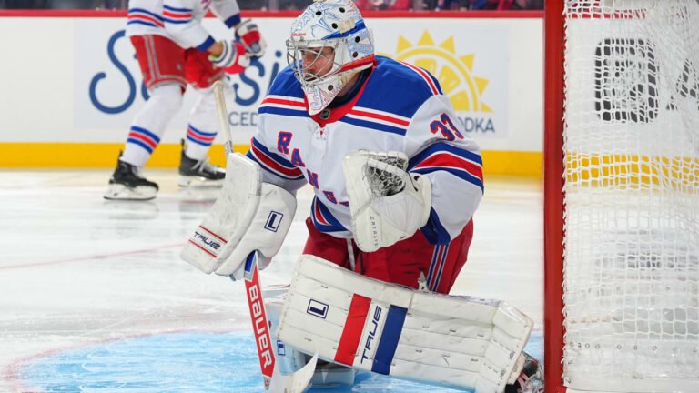 Dylan Garand crouches in the Rangers crease in a white No. 33 road jersey, with the net to his left.