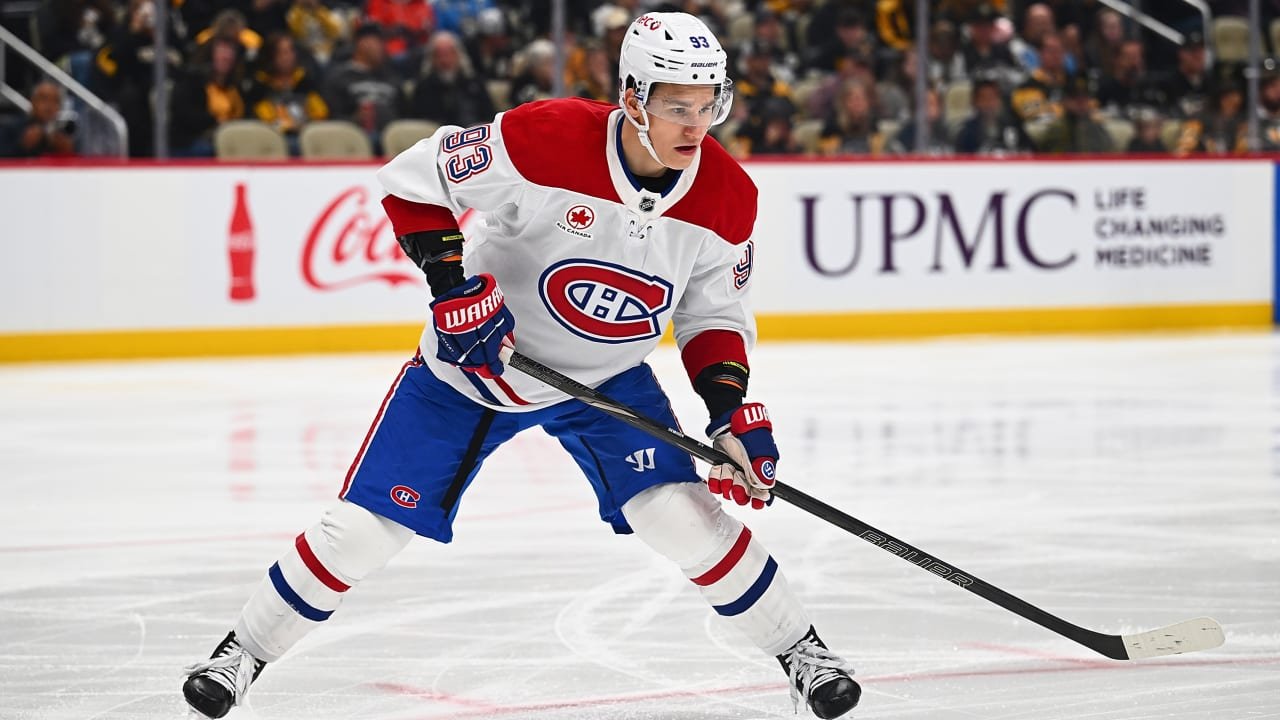 Ivan Demidov carrying his stick while skating in a white Canadiens jersey.