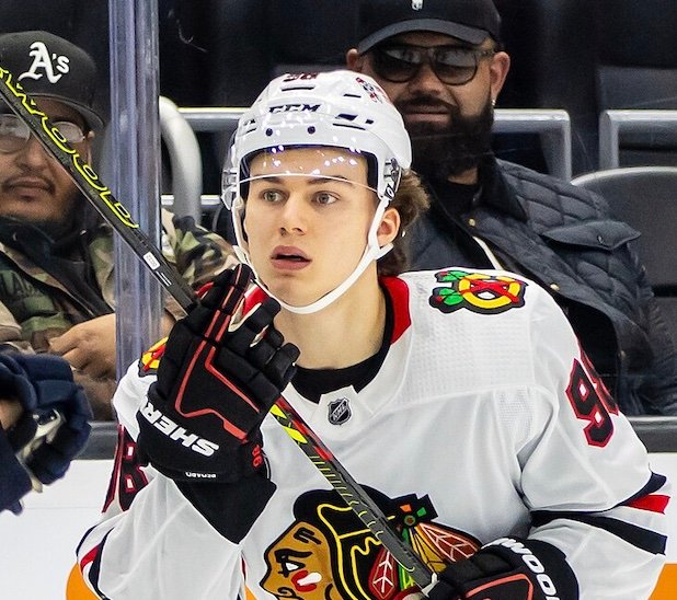 Connor Bedard in a white Chicago Blackhawks jersey