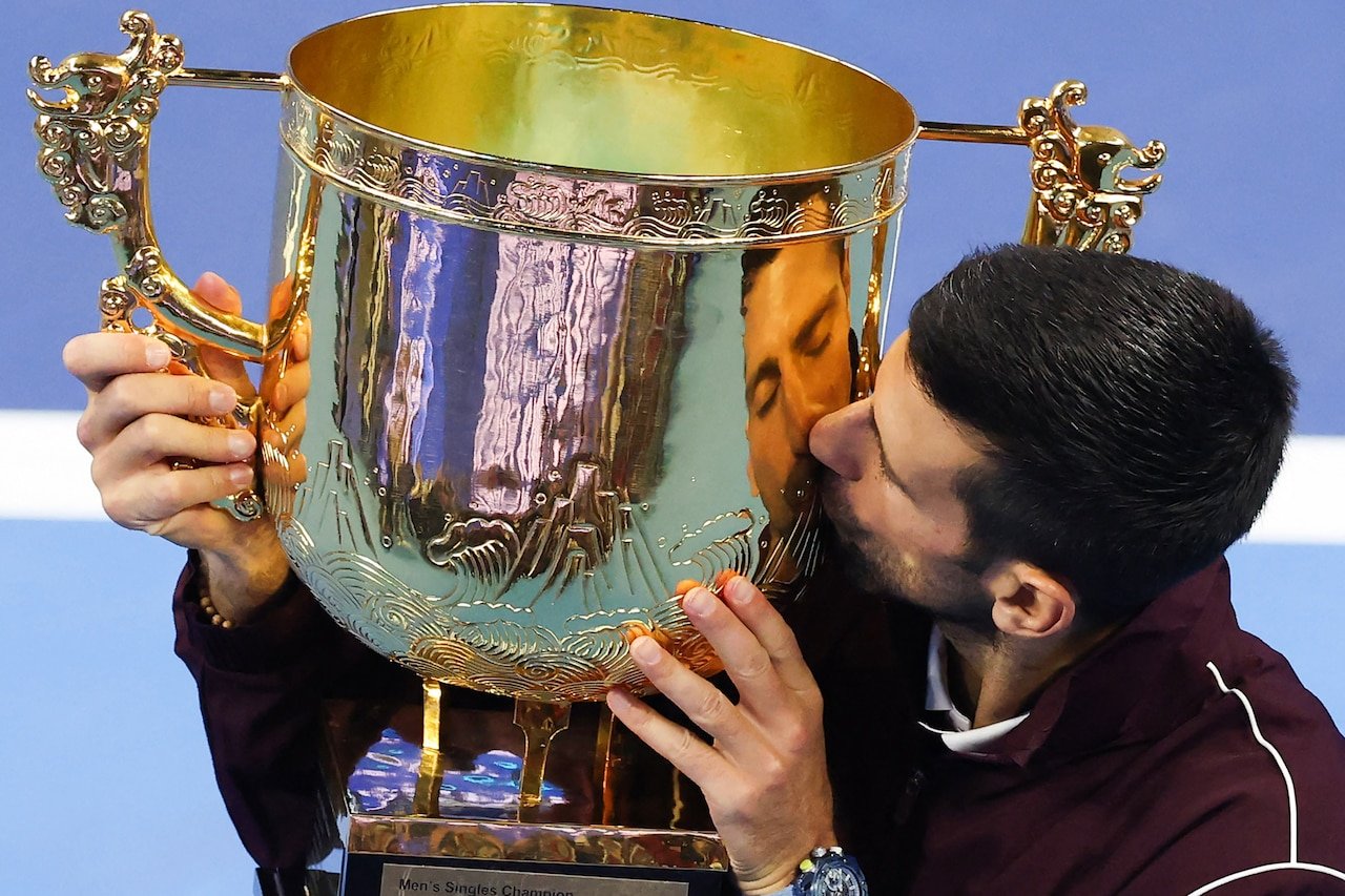 Novak Djokovic kisses the China Open trophy.