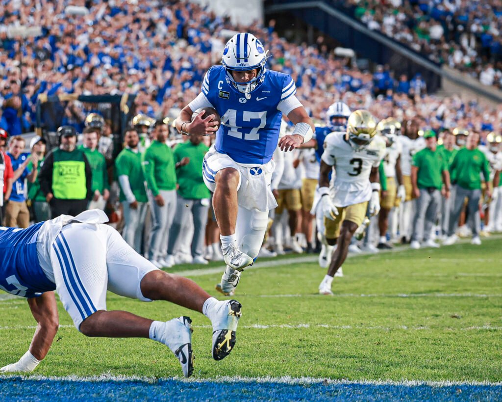 BYU quarterback Bear Bachmeier runs with the ball toward the end zone against Notre Dame.
