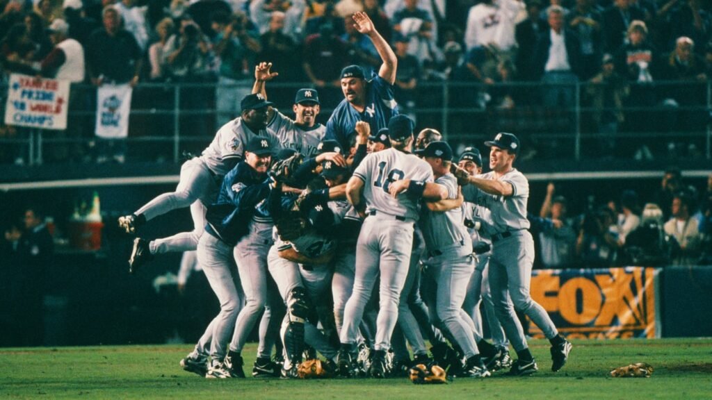 Yankees players gather in a celebratory pile on the field after their 1998 World Series victory.