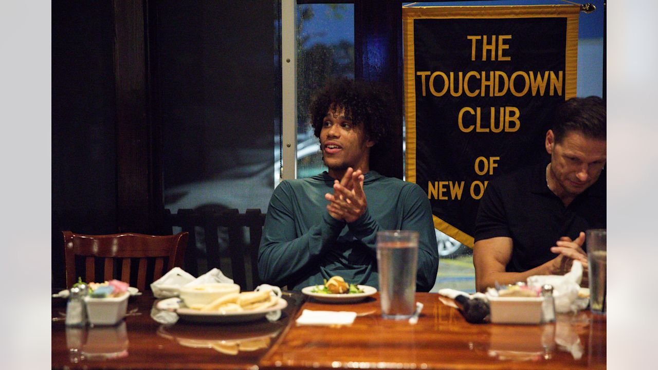 Jordyn Tyson applauds while seated at the Touchdown Club of New Orleans dinner.