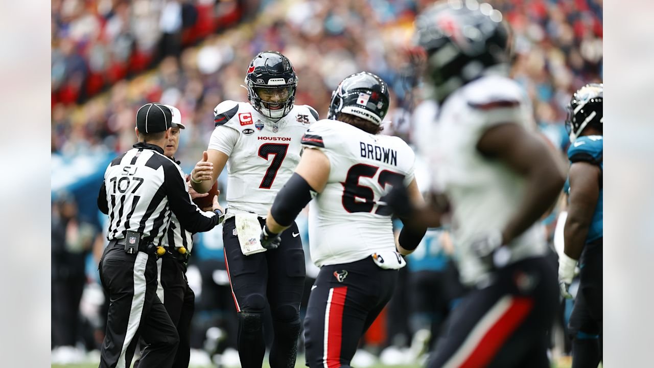 C.J. Stroud, number 7, stands near teammates and an official during Houston’s game against Jacksonville.