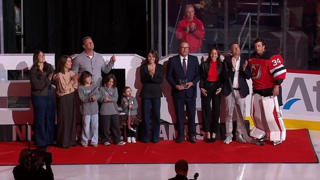 Jake Allen and his family stand on the ice during New Jersey’s silver-stick ceremony.