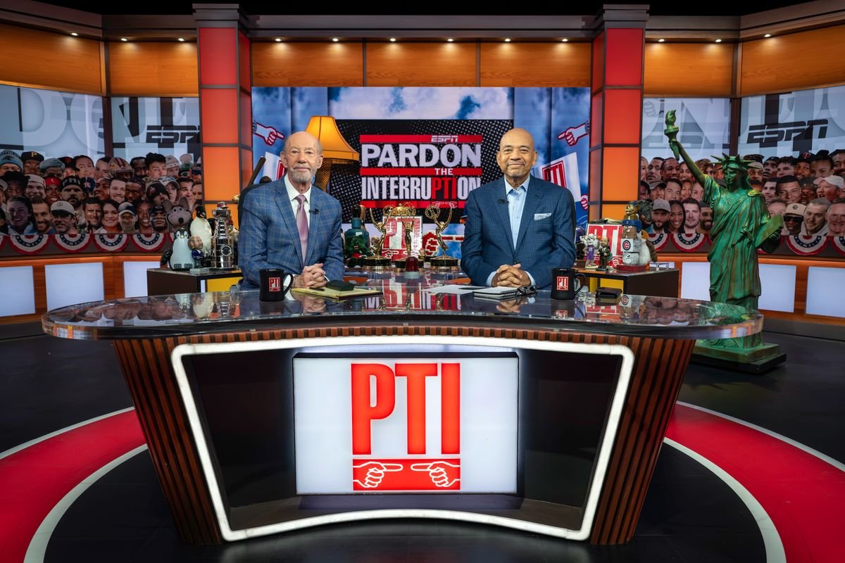 Tony Kornheiser, left, and Michael Wilbon sit behind the Pardon the Interruption studio desk.