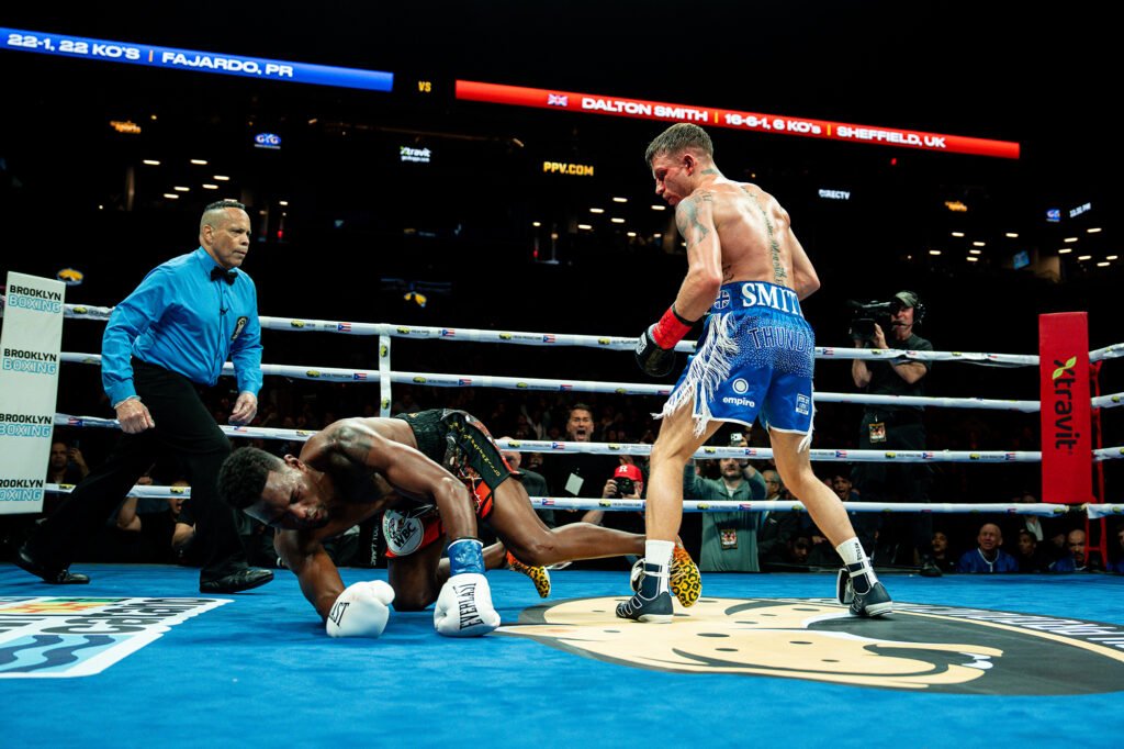 Dalton Smith stands beside Subriel Matias following a knockdown in their January 2026 title fight