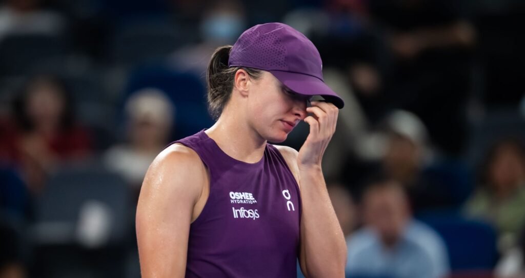 Iga Swiatek in a purple cap and shirt at the 2026 Wuhan Open