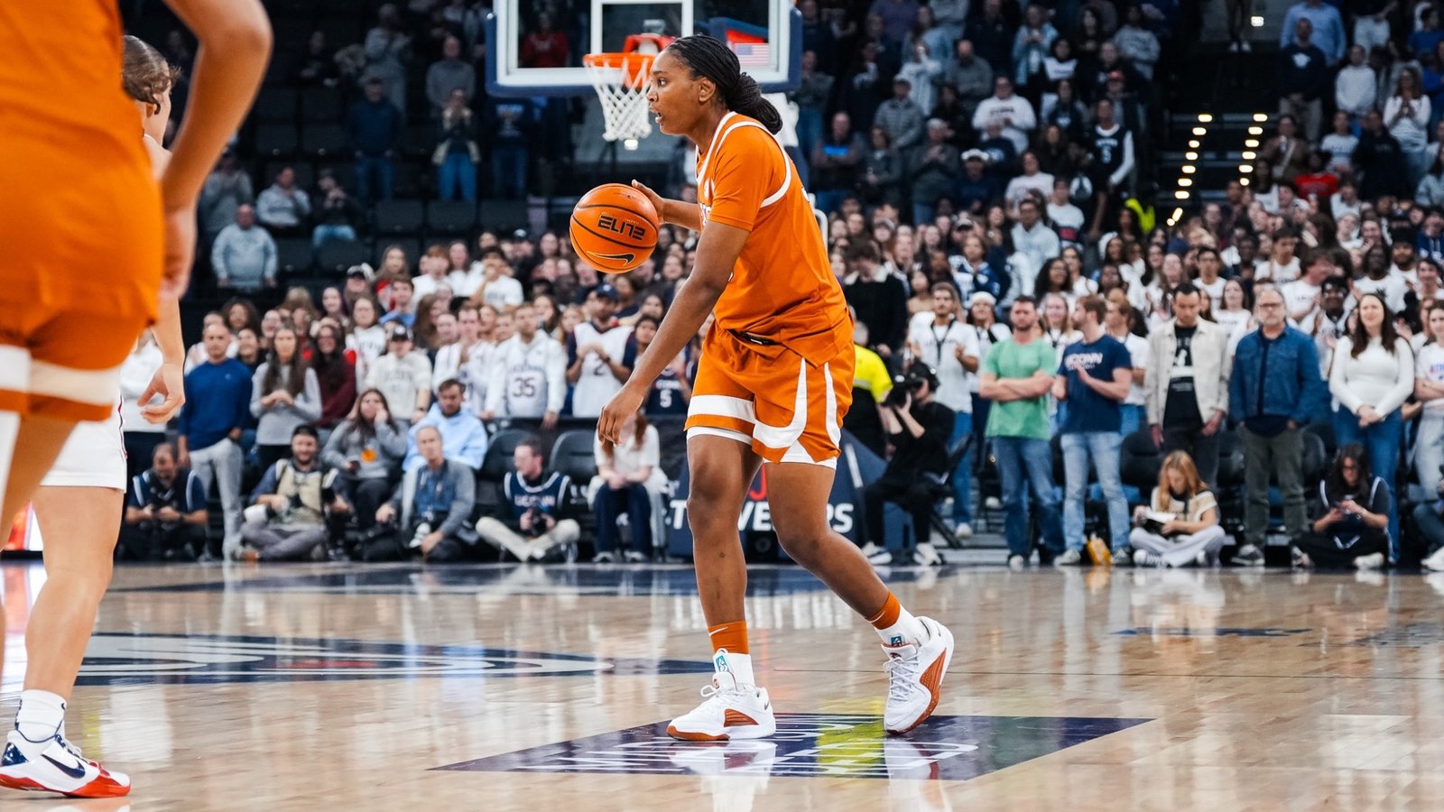 Madison Booker handles the basketball during Texas’s exhibition at UConn.