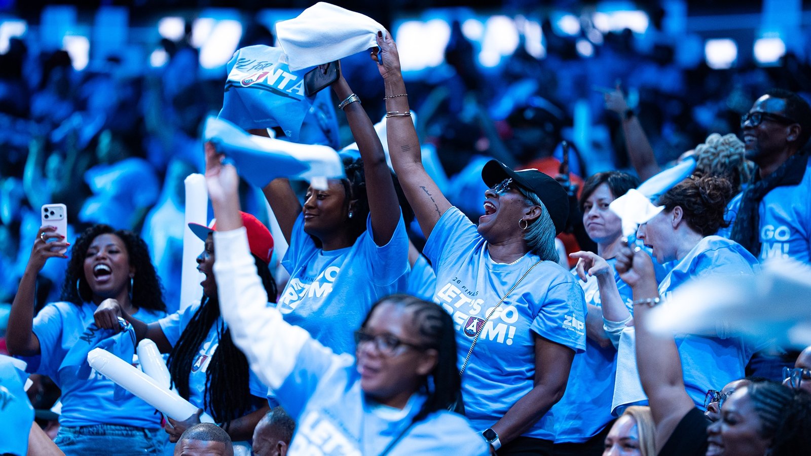Atlanta Dream supporters wave towels and cheer in the stands.