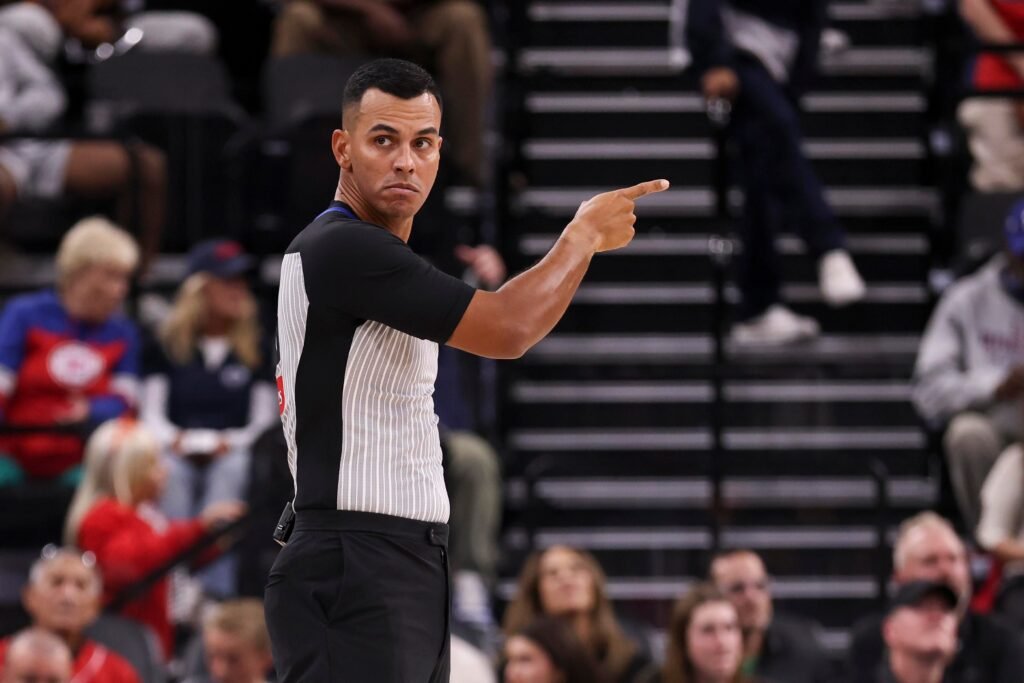 NBA referee Italo Araujo points during a preseason game at Intuit Dome on October 14, 2026.