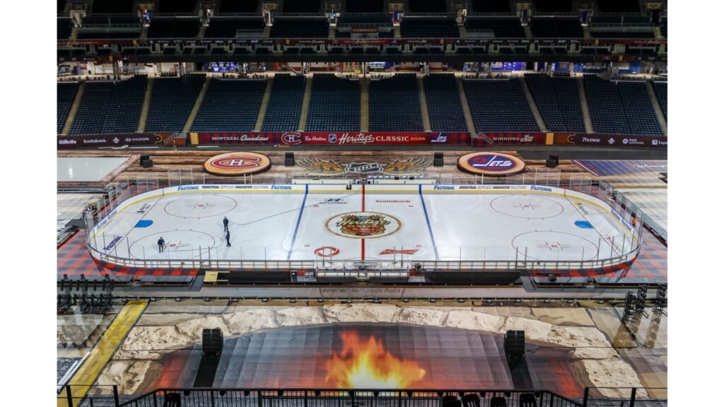 Workers prepare the Heritage Classic ice inside Princess Auto Stadium.