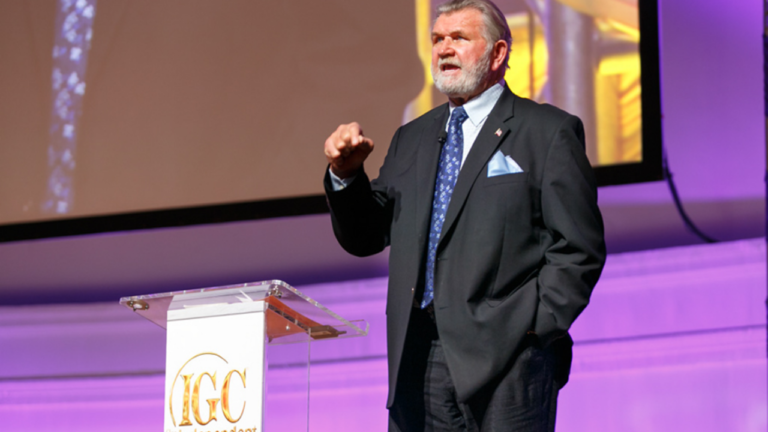 Mike Ditka speaks at a lectern during an IGC Show in Chicago.