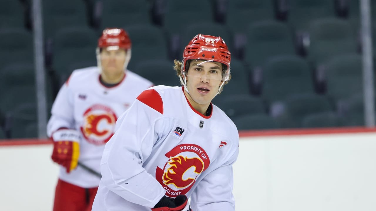 Calgary Flames players skate in white practice jerseys on October 7, 2026.